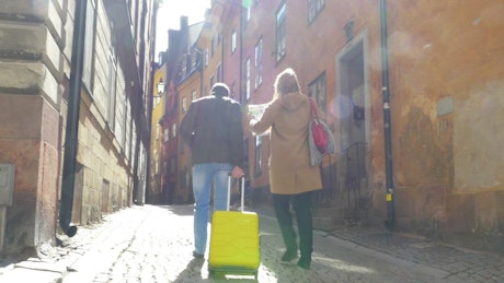 Tourists walking through a city with their luggage