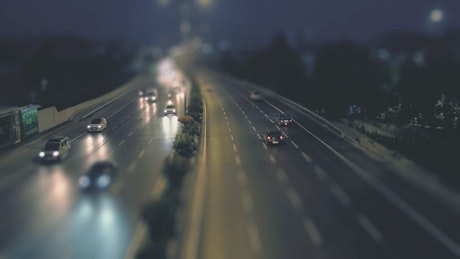 Traffic along a highway on a rainy night.