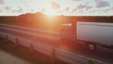 Trailer traveling on a road at sunset in 3D.
