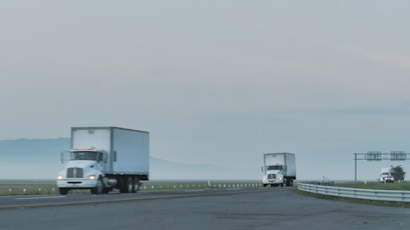Trailers on a foggy road