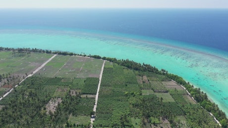 Tropical island near a coral atoll reef.
