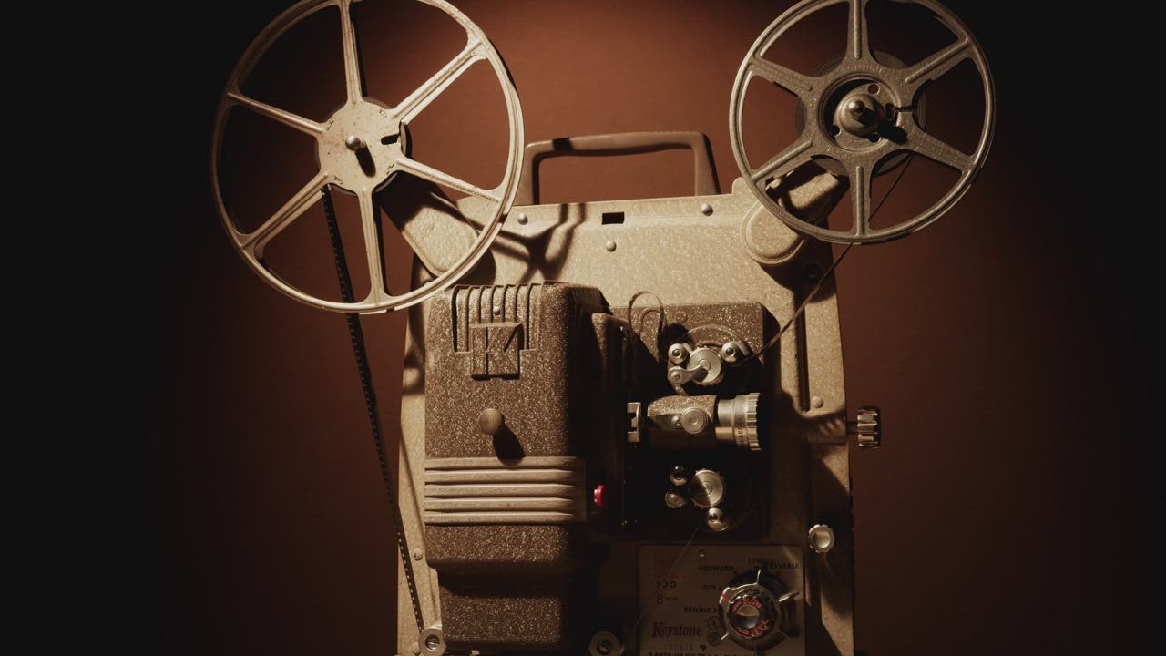 Turning on a vintage film projector - Free Stock Video