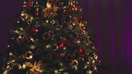 Twinkling christmas tree with purple background.