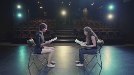 Two actresses rehearsing in an empty theater