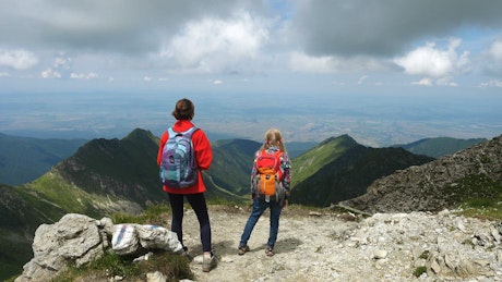 Two girls enjoying the view in the mountain.
