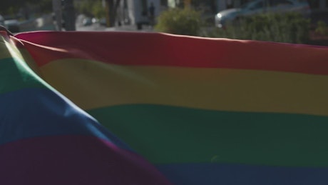 Two men holding a rainbow flag