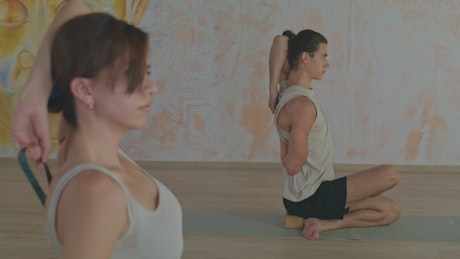Two people practicing yoga together.