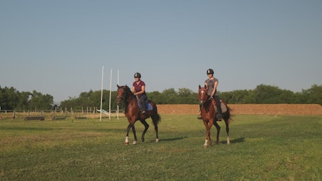 Two young riders training for competition.