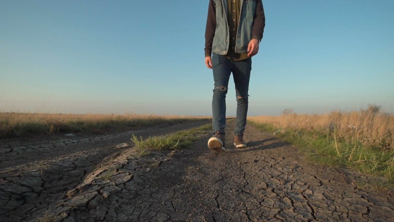 Unknown Man Walking In A Dirt Road Free Stock Video