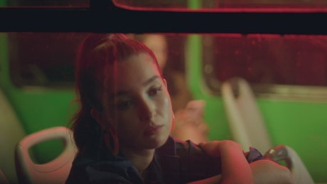 Urban girl through the window of a bus