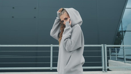 Urban girl with a grey hoodie.