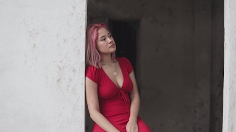 Urban trendy woman's portrait wearing a red dress