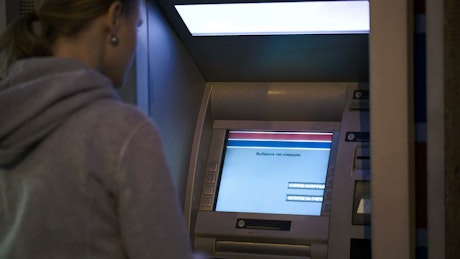 Using an ATM machine.