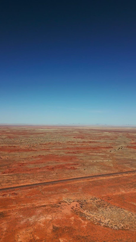 Vast and flat desert in a view from above.