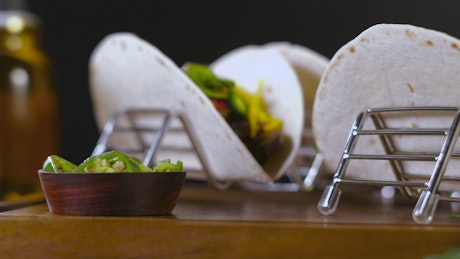 Vegetarian tacos on a wooden board.