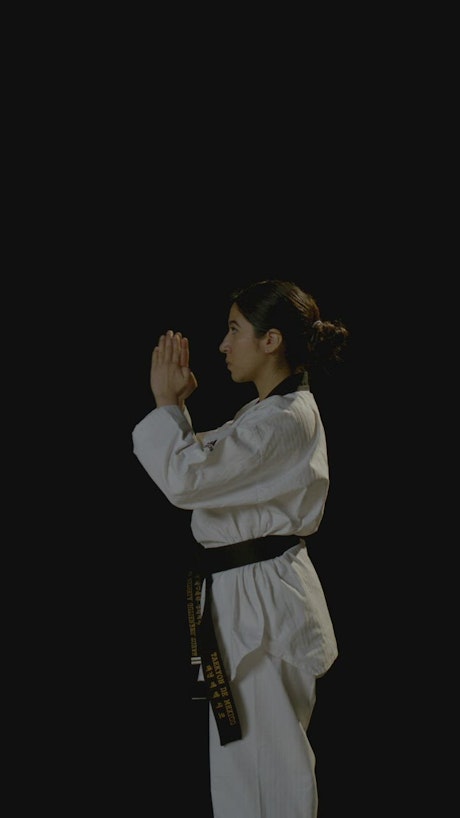 Vertical video of a young karateka woman.
