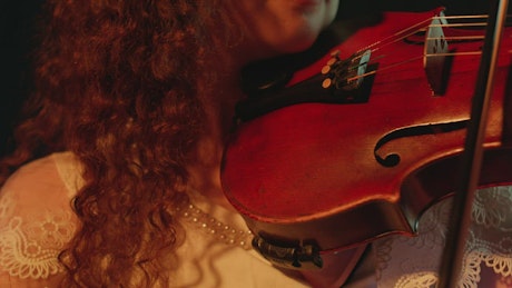 Very close shot of a violinist playing.