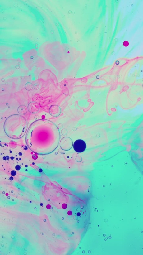 Vibrant colored ink flowing in an abstract video.