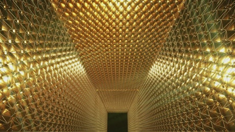 Video loop of an awards hall with gold walls.