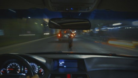 View from inside a car in night traffic.
