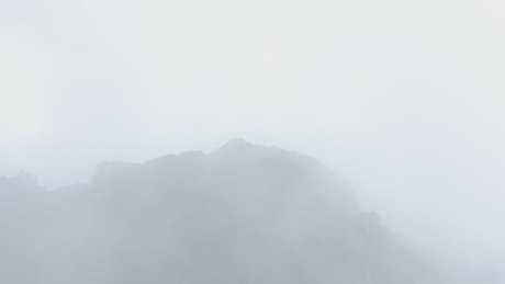 View from the air of a mountain covered by mist.