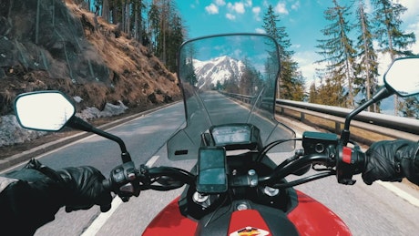 View of a motorcycle driving in the mountains.