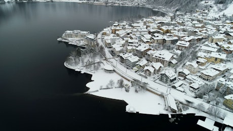 View of a snowy town and a lake