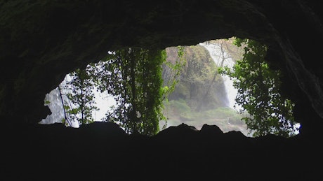 View of a waterfall from a cave