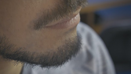 Vlogger testing a lapel mic on his neck.