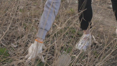 Volunteer picking up trash from the grass