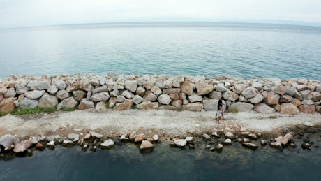 Walking along a stone sea wall