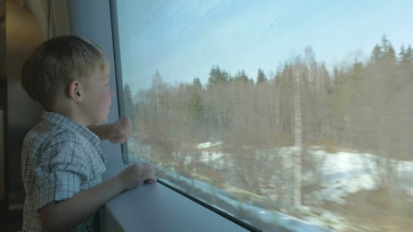 Watching the world go by from a train.