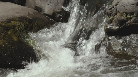 Water crashes among rocks