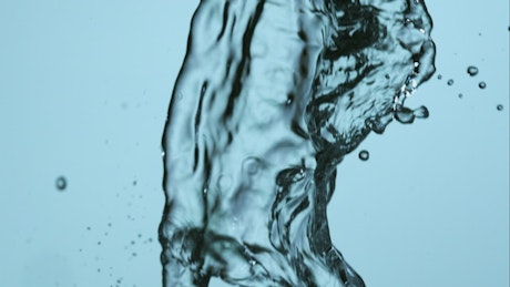 Water falling in slow motion on a blue background.