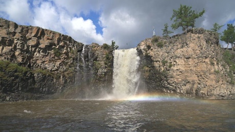 Waterfall with rainbow mist