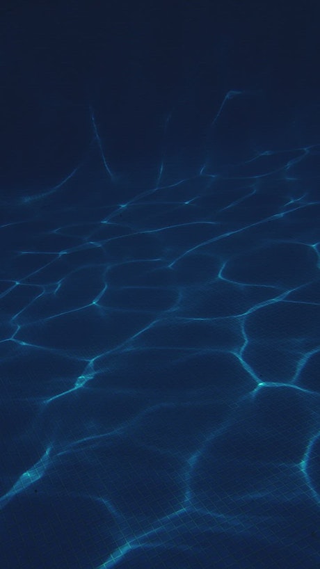 Wave's lines of light underwater in a pool
