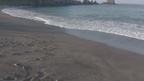 Waves on the sand of a sunny beach.