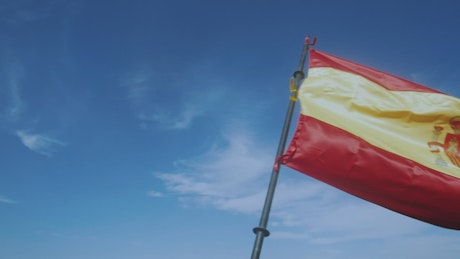 Waving the flag of Spain in slow motion.
