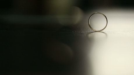Wedding rings on a black surface.
