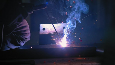 Welding sparks and flame by cutting metal.
