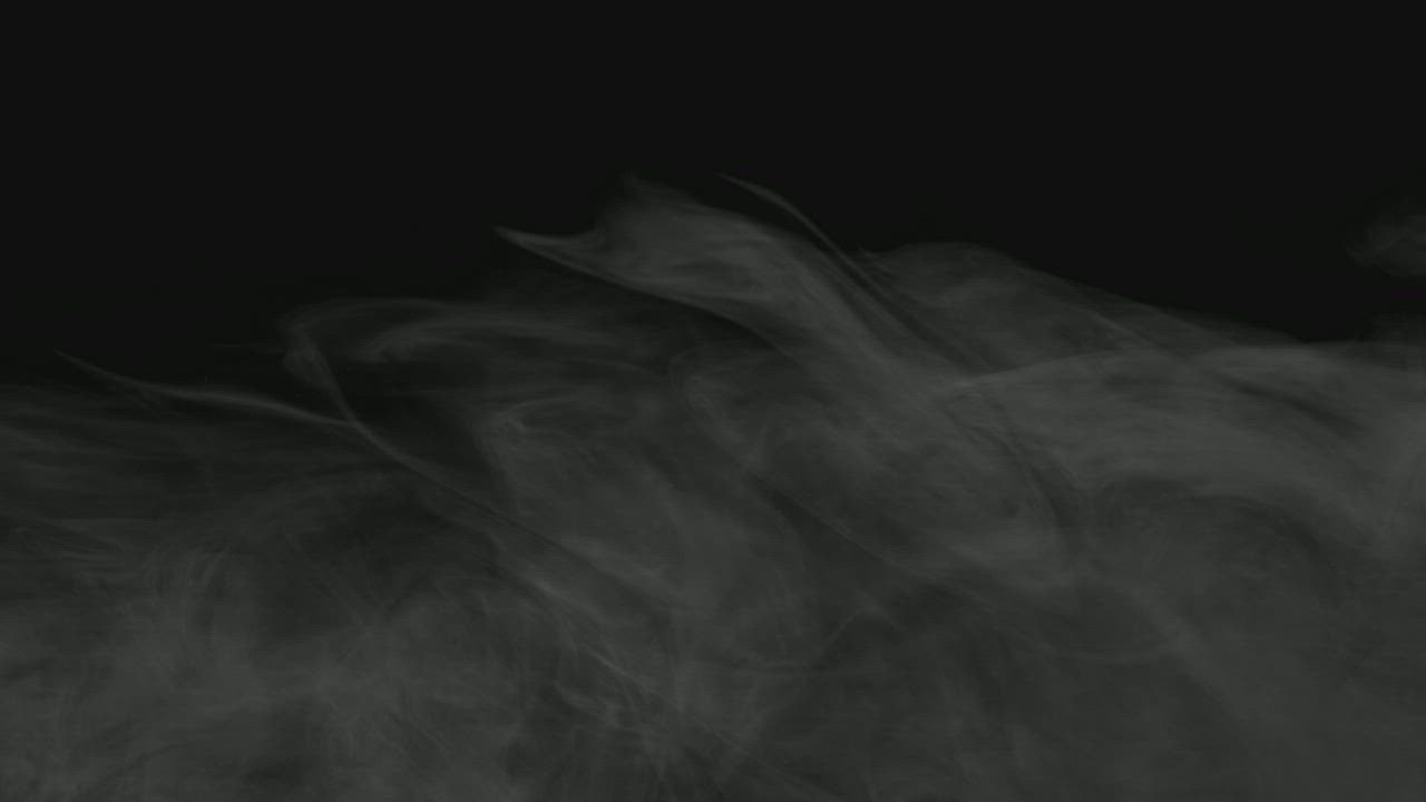 Wispy smoke floating on a dark background - Free Stock Video