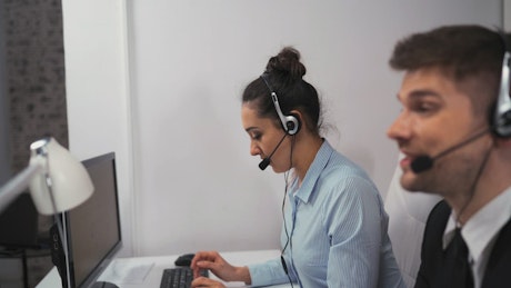 Woman and man working at a call center