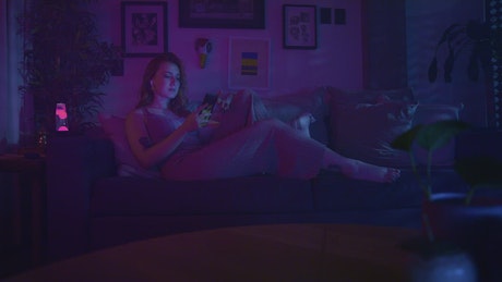 Woman at night lying down using her cell phone