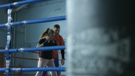 Woman boxing with a punching bag.