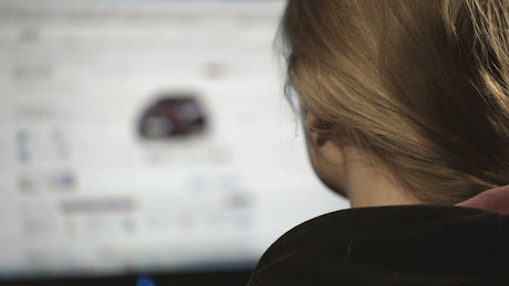 Woman browsing cars online.