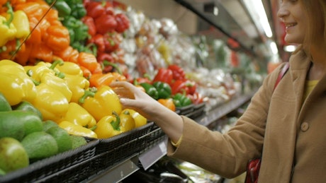 Woman buying peppers