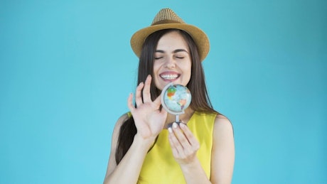Woman chooses a country to travel on a globe