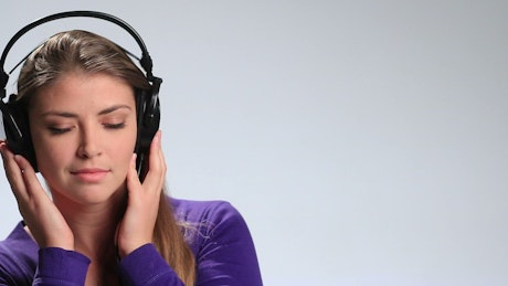 Woman dancing with music from her headphones