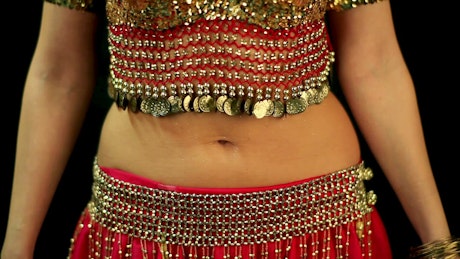 Woman doing a belly dance in a red dress