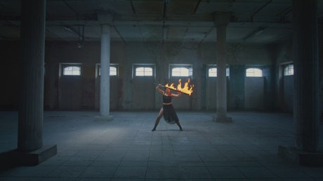 Woman doing a dance with a fire sword